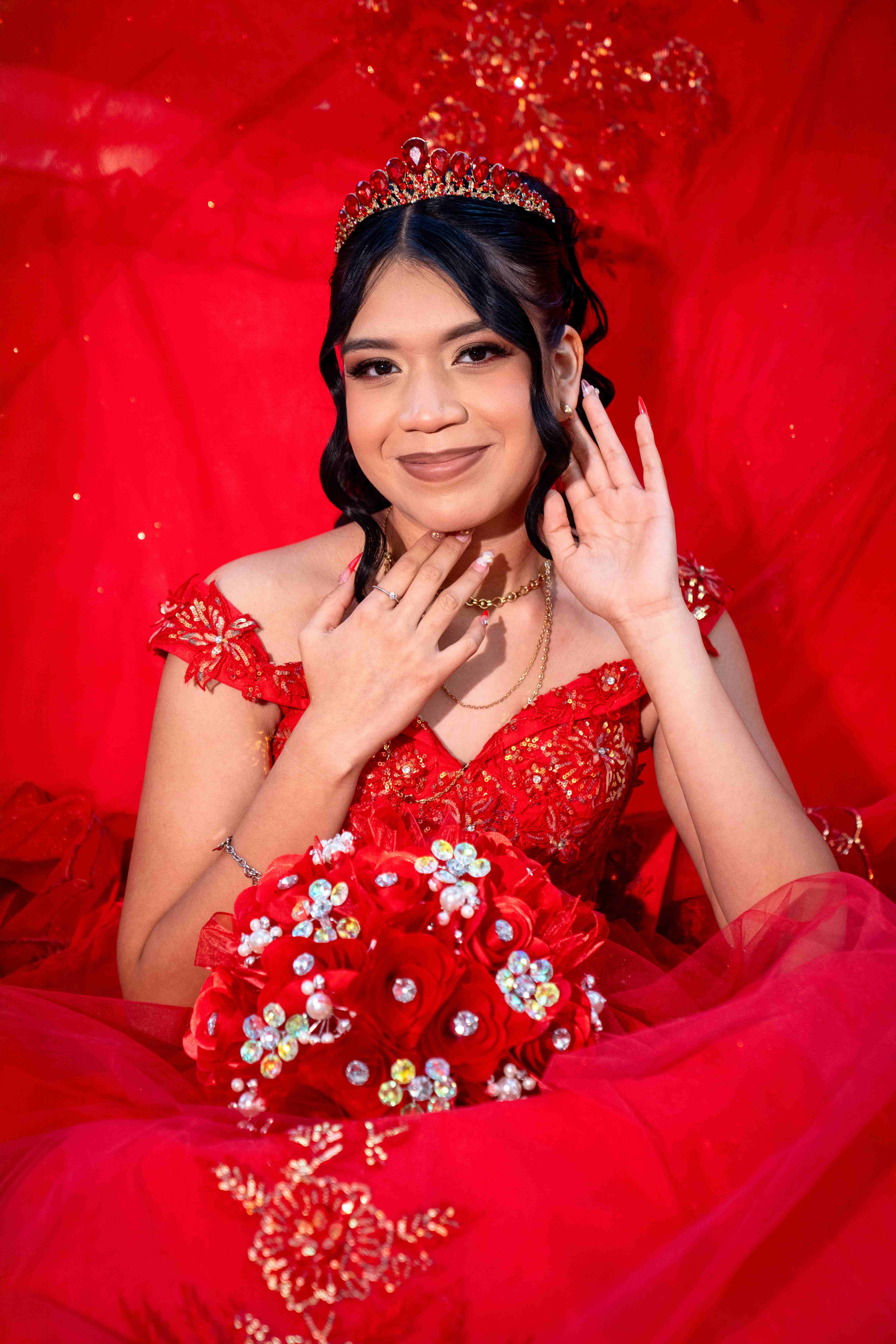 Studio portrait of quinceañera in red gown